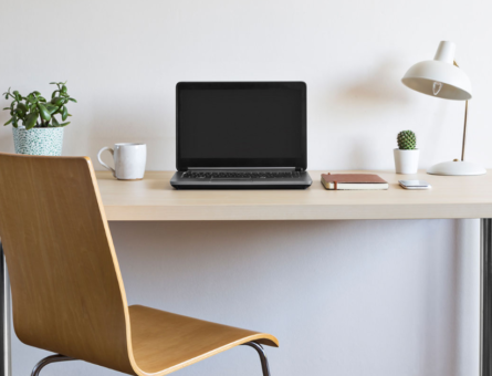 Photo of a desk and office chair against a white background